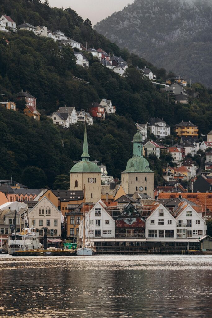 Scenic view of Bergen's historic waterfront with colorful buildings and church spires.